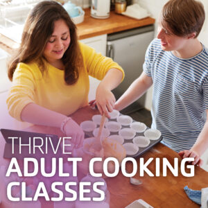 Adult and youth at a kitchen island making cupcakes